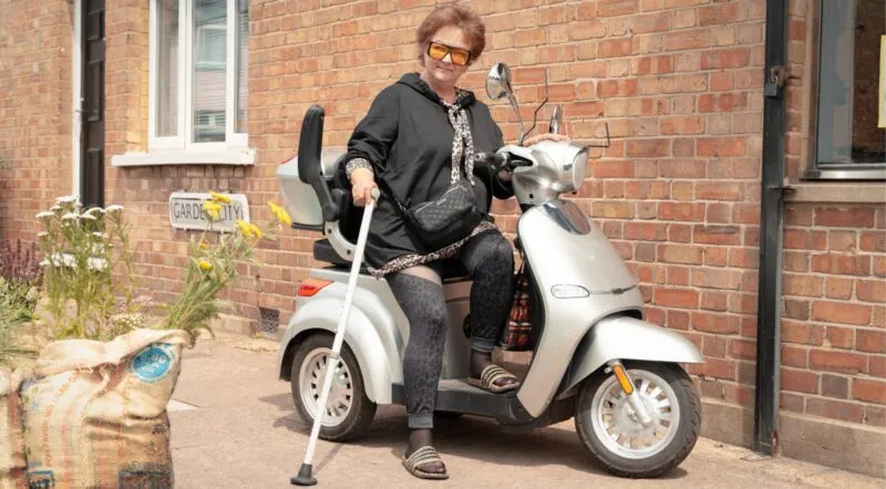 Lady riding a scooter in Edgware Town Centre